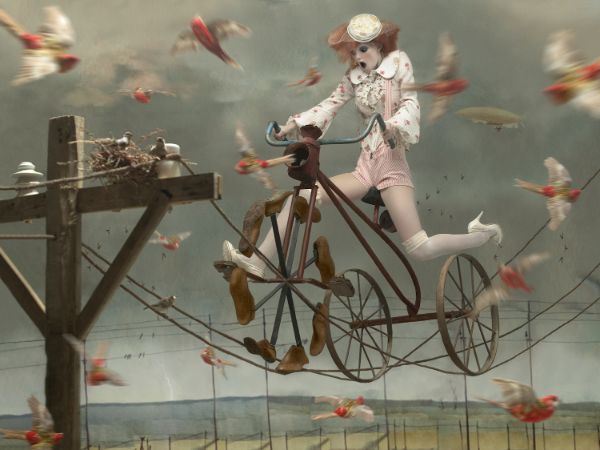 Eugenio Recuenco fashion girl on bike with birds photography
