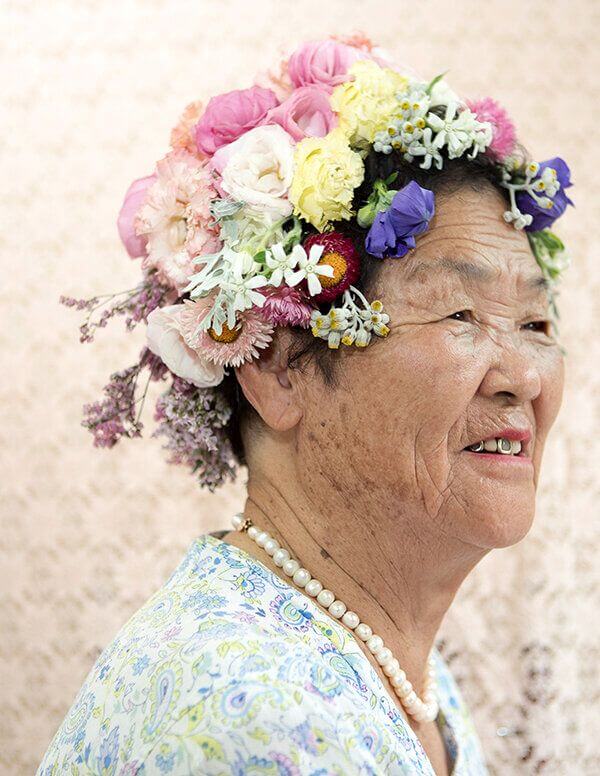 Ziesook You portrait of senior woman with multicoloured flowers